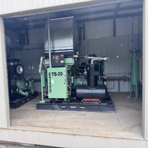 New Surplus Skid Mounted Duplex Rotary Screw Air Compressor Package Housed In An Insulated And Heated Metal Building